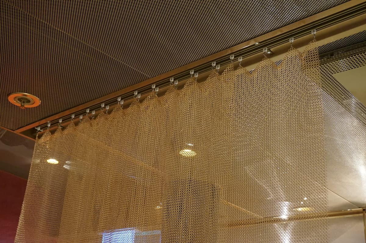 Double rail for lighter metal draperies, recessed in the ceiling